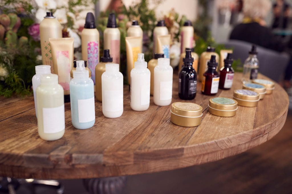 Display Of Beauty Products On Sale In Hairdressing Salon. Maximize your salon retail profits for optimal beauty product sales. Salon merchandising tips, and making a complete encore retail strategy. Encore Salon Suites, the best salon suite provider in Atlanta, GA. Hair salon suites near me, salon suites near me
